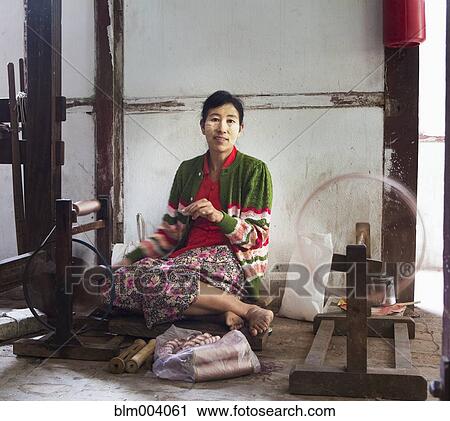 Asian woman working on loom View Large Photo Image Stock Image - Asian woman working on loom. Fotosearch