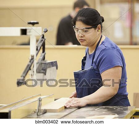 Stock Image - Asian woman working on workshop. Fotosearch