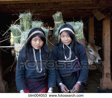Stock Image - Asian women carrying baskets on backs. Fotosearch
