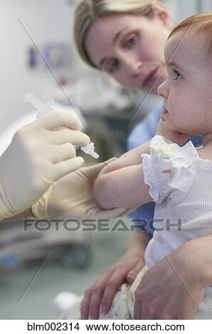 Picture - Baby getting shot at hospital. Fotosearch