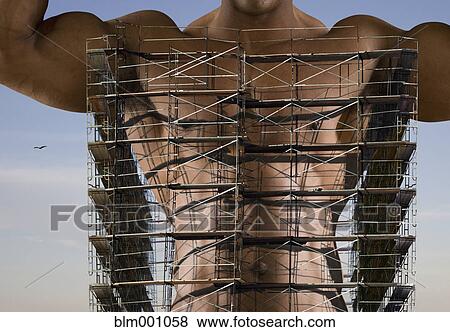 Stock Photo - Bare chested African man with scaffolding around torso. Fotosearch