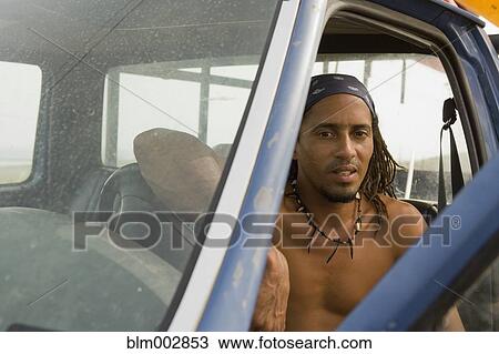 Bare chested Hispanic man sitting in cab of truck View Large Photo Image Stock Image - Bare chested Hispanic man sitting in cab of truck. Fotosearch