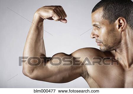 Bare chested mixed race man flexing biceps View Large Photo Image Stock Photo - Bare chested mixed race man flexing biceps. Fotosearch