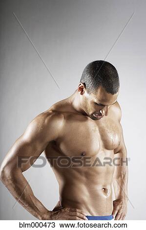 Stock Image - Bare chested mixed race man. Fotosearch