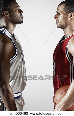Stock Image - Basketball players standing face to face. Fotosearch