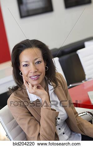 Black businesswoman smiling in the lobby View Large Photo Image Stock Image - Black businesswoman smiling in the lobby. Fotosearch