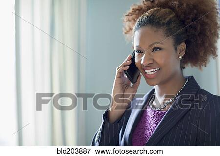 Stock Photo - Black businesswoman talking on cell phone. Fotosearch
