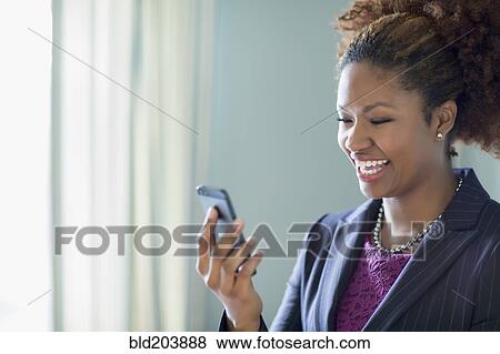 Stock Photo - Black businesswoman talking on cell phone. Fotosearch