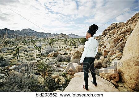 Stock Image - Black runner in desert landscape, Joshua Tree National Park, California, United States. Fotosearch