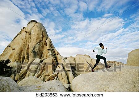 Stock Image - Black runner in desert landscape, Joshua Tree National Park, California, United States. Fotosearch