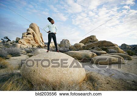 Stock Photograph - Black runner in desert landscape, Joshua Tree National Park, California, United States. Fotosearch