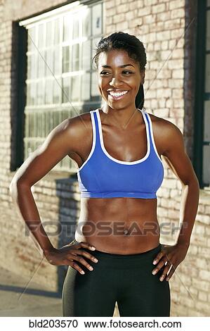 Black runner smiling on city street View Large Photo Image Stock Image - Black runner smiling on city street. Fotosearch