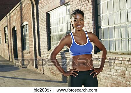 Black runner smiling on city street View Large Photo Image Stock Image - Black runner smiling on city street. Fotosearch
