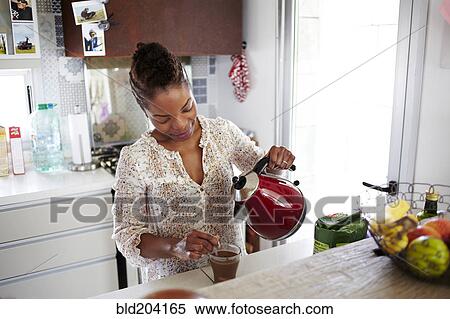 Black woman making cup of tea View Large Photo Image Stock Photography - Black woman making cup of tea. Fotosearch