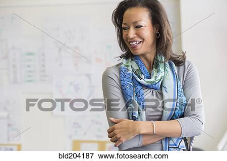 Stock Photo - Black woman smiling in classroom. Fotosearch
