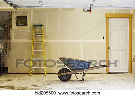 Stock Image - Blue Wheelbarrow in Garage. Fotosearch