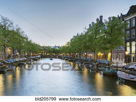 Stock Photo - Boats in a Tree Lined Canal at Dusk. Fotosearch