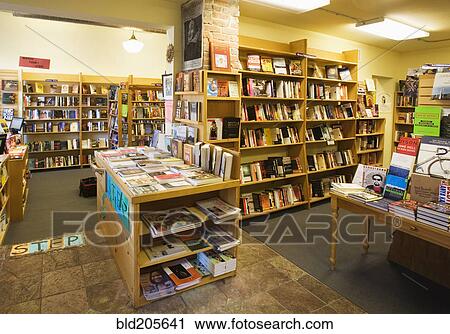 Stock Image - Books on shelves and tables in bookstore. Fotosearch