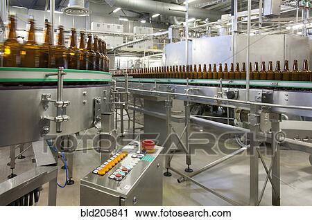 Stock Image - Bottles on production line in bottling plant. Fotosearch