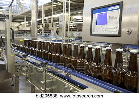 Stock Photo - Bottles on production line in bottling plant. Fotosearch