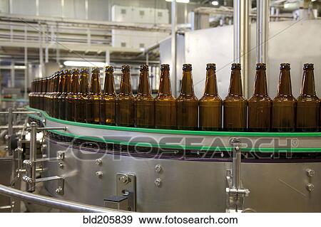 Stock Photo - Bottles on production line in bottling plant. Fotosearch