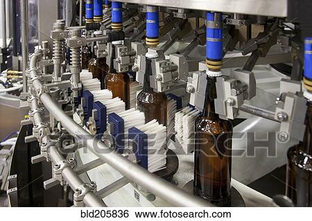 Stock Photograph - Bottling machine in factory. Fotosearch