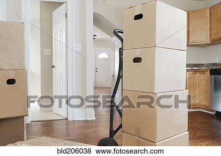 Stock Photo - Boxes and cartons stacked in a house. Fotosearch