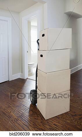 Stock Photo - Boxes and cartons stacked in a house. Fotosearch