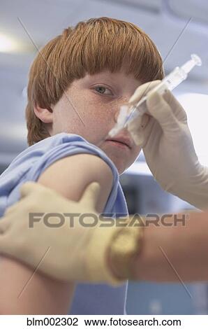 Boy getting shot at hospital View Large Photo Image Stock Image - Boy getting shot at hospital. Fotosearch