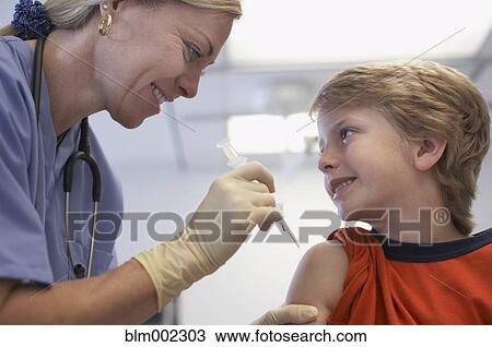 Boy getting shot at hospital View Large Photo Image Stock Image - Boy getting shot at hospital. Fotosearch