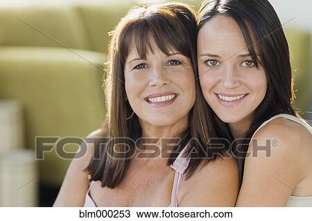 Stock Image - Brazilian mother and daughter hugging. Fotosearch