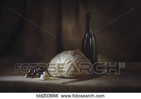 Stock Photograph - Bread, fruit, wine and cheese on table. Fotosearch