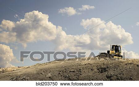 Stock Image - Bulldozer working in quarry. Fotosearch