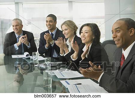 Stock Photo - Business people clapping in conference room. Fotosearch
