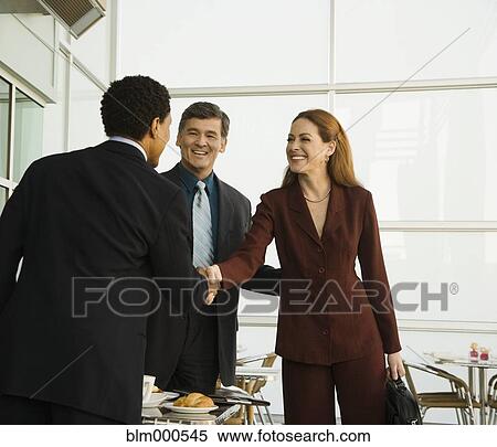 Stock Photography - Business people having meeting in restaurant. Fotosearch