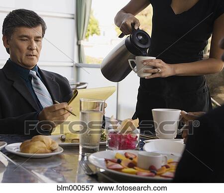 Business people having meeting over breakfast in restaurant View Large Photo Image Stock Photo - Business people having meeting over breakfast in restaurant. Fotosearch