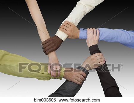 Business people holding co-workers wrists View Large Photo Image Stock Photography - Business people holding co-workers wrists. Fotosearch