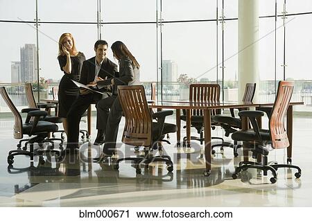 Stock Image - Business people in conference room for meeting. Fotosearch