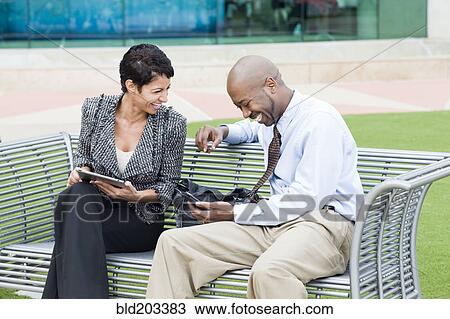 Business people laughing together outdoors View Large Photo Image Stock Image - Business people laughing together outdoors. Fotosearch