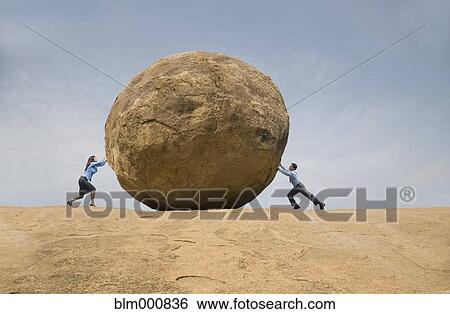 Stock Photograph - Business people pushing large rock against each other. Fotosearch