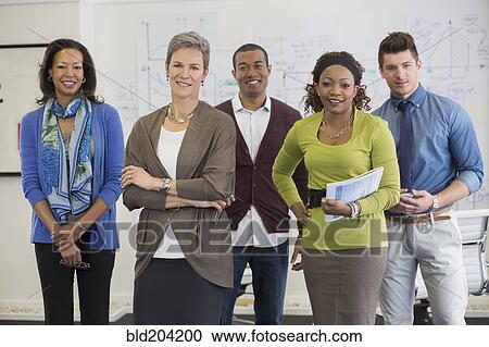 Stock Image - Business people smiling in office. Fotosearch