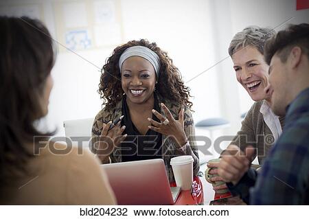 Stock Image - Business people talking in meeting. Fotosearch