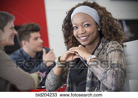 Stock Image - Business people talking in meeting. Fotosearch