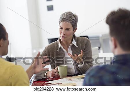 Business people talking in office View Large Photo Image Stock Photo - Business people talking in office. Fotosearch