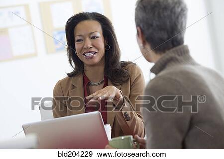 Stock Photo - Business people talking in office. Fotosearch