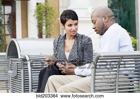 Picture - Business people talking outdoors. Fotosearch