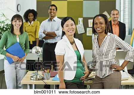 Stock Image - Business people working together in office. Fotosearch