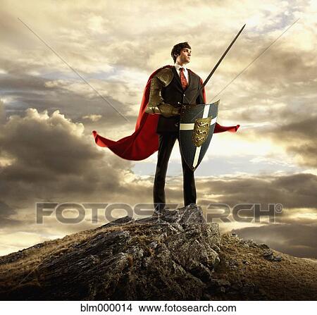 Businessman in cape holding shield and sword View Large Photo Image Picture - Businessman in cape holding shield and sword. Fotosearch