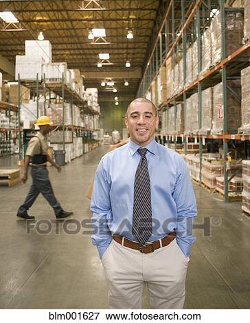 Stock Photo - Businessman in warehouse. Fotosearch