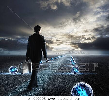 Businessman walking on path towards city View Large Photo Image Stock Image - Businessman walking on path towards city. Fotosearch